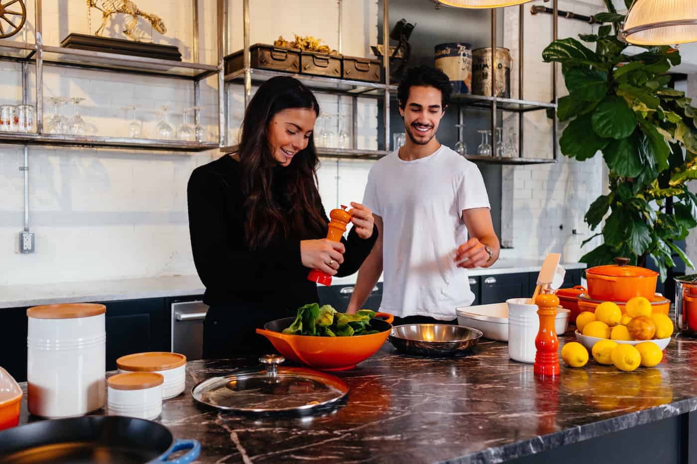 couple making homemade salads in kitchen
