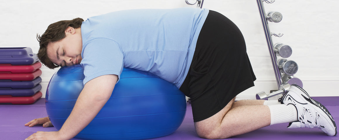 overweight man sleeping on exercise ball